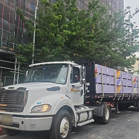 Flatbed loaded with purple sheetrock