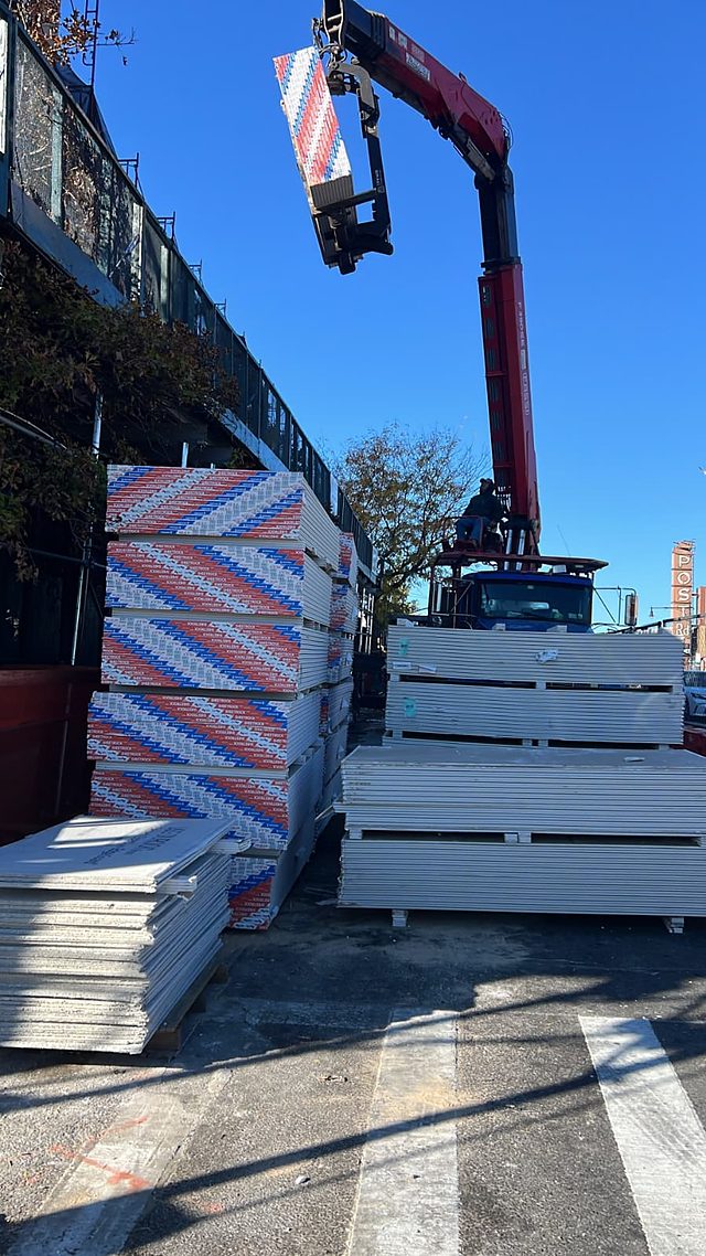 Boom truck delivering drywall in Brooklyn
