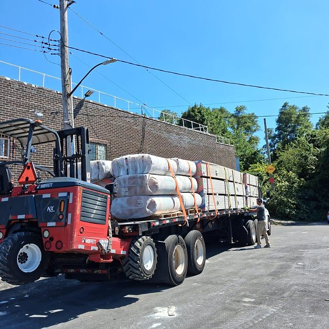 Flatbed loaded with insulation and drywall
